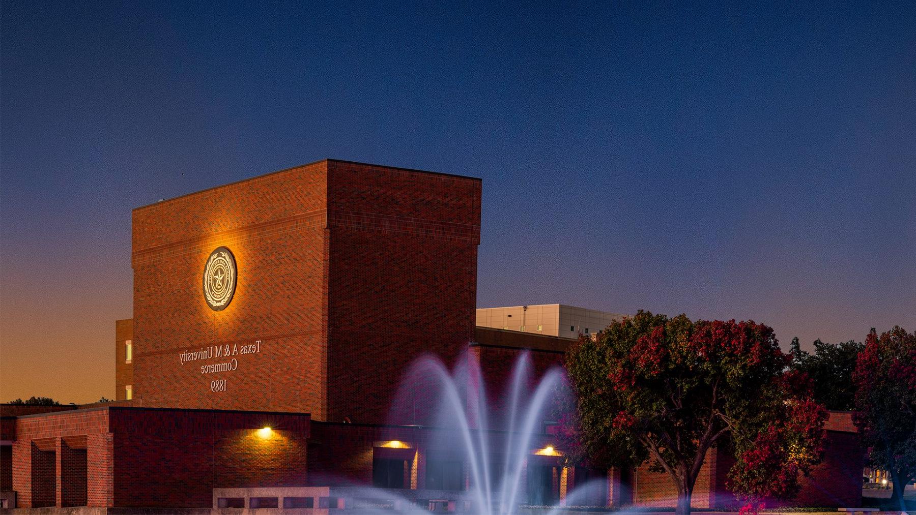 fountain on campus with building in the background.