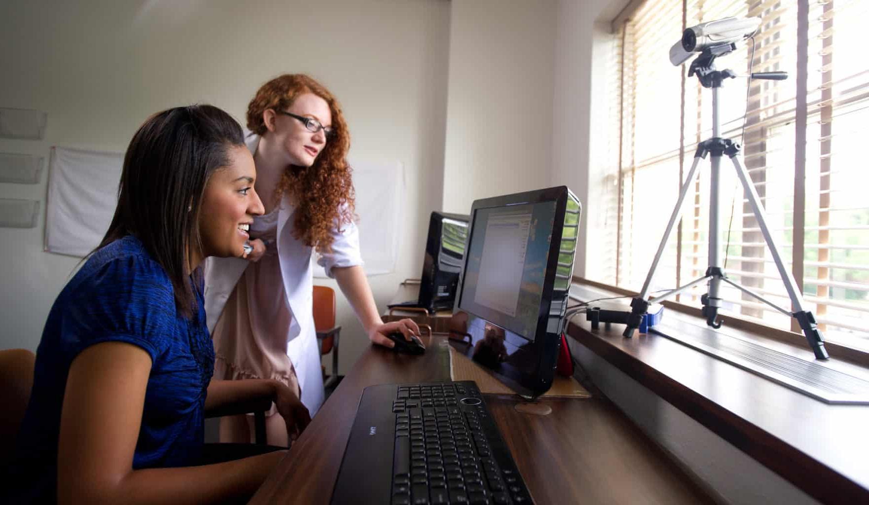 Psychology lab with two female students working at computer.