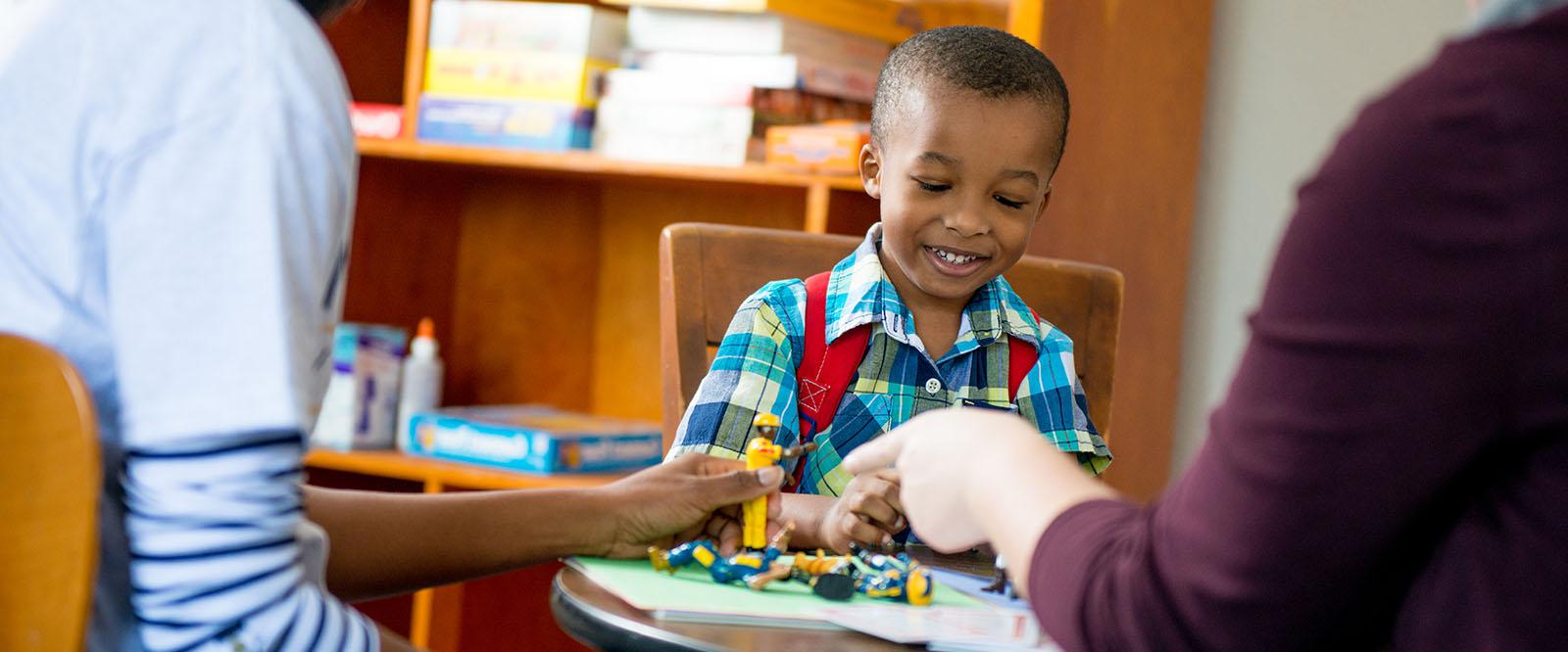 Young kid playing at a table. 