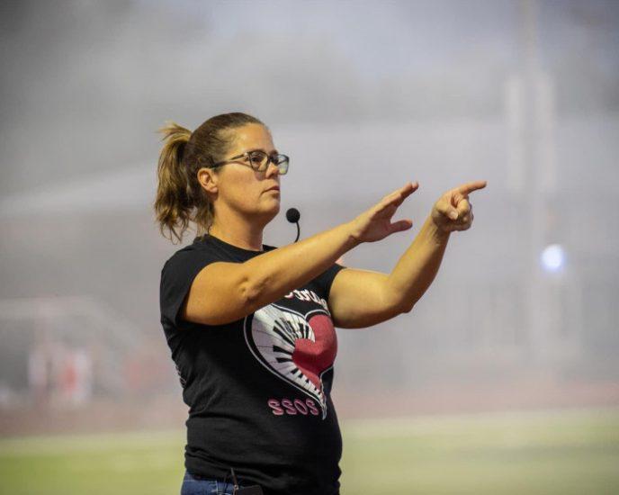 A band director issues instructions to their ensemble.